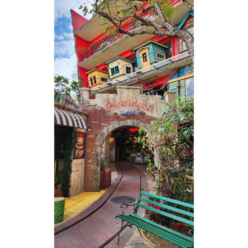 Entrance to Depot Island Station with colorful buildings in American Village Okinawa