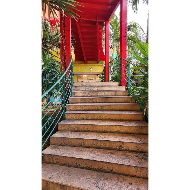 Outdoor staircase surrounded by tropical plants at American Village in Chatan, Okinawa