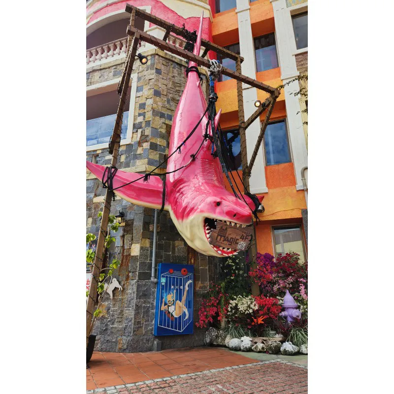 Giant pink shark statue hanging outside a building at American Village in Chatan, Okinawa