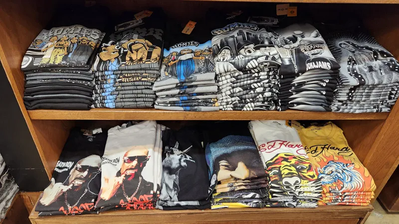 Graphic streetwear T-shirts folded on shelves at American Village in Chatan, Okinawa