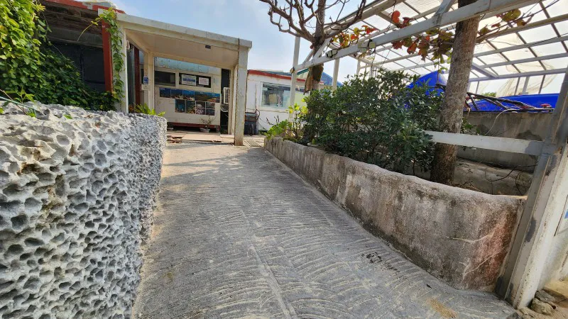 Entrance path leading to the building at Yomitan Coral Farm in Okinawa