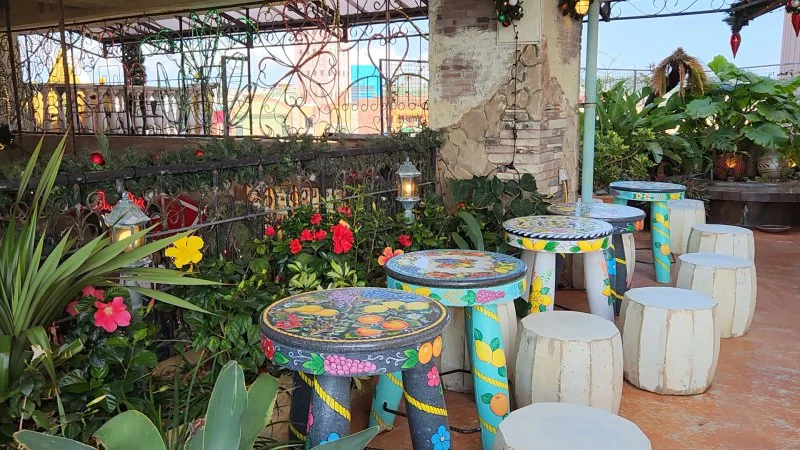 Outdoor seating with colorful painted tables and plants at American Village in Chatan, Okinawa