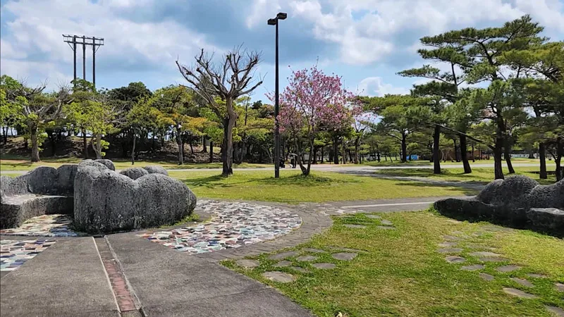 Landscaped area with stones and cherry blossoms at Kitanakagusuku Sports Park Okinawa