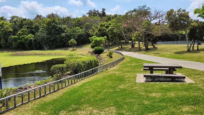 Wooden table near a pond at Kitanakagusuku Sports Park Okinawa