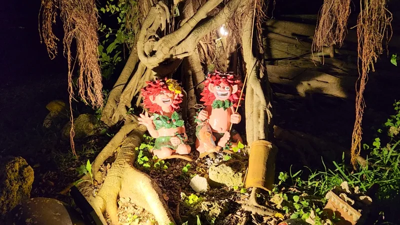 Kijimuna yokai figures with red hair under a banyan tree at night