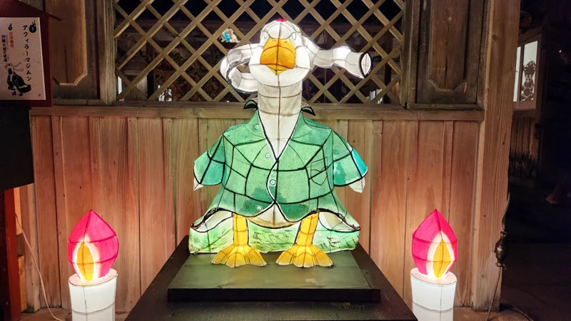 Duck Afira Majimum shaped yokai lantern in a green jacket with candles at the Ryukyu Yokai Festival