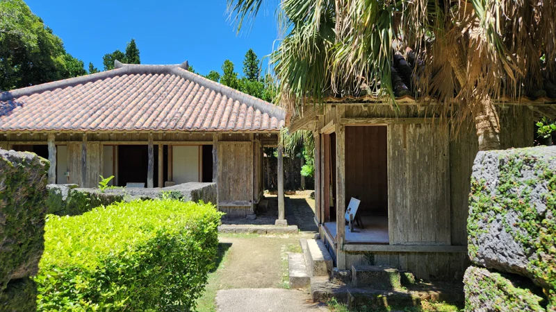 Traditional Okinawan wooden house with red tile roof at Native Okinawa Village