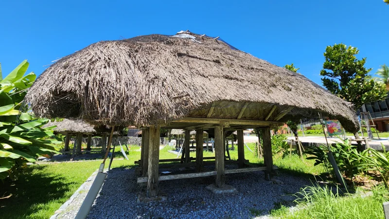 Traditional raised wooden granary with thatched roof in Okinawa