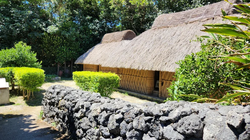 Traditional bamboo and thatch house with volcanic stone wall
