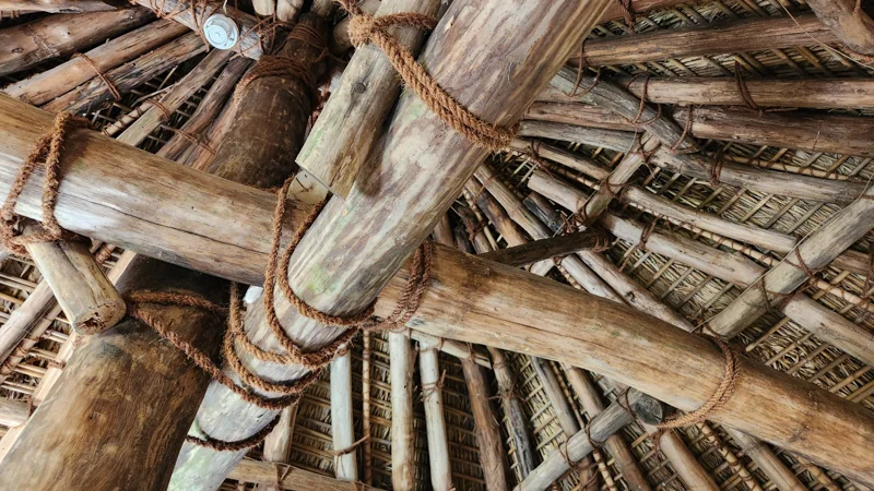 Wooden roof structure tied with traditional ropes at Native Okinawa Village