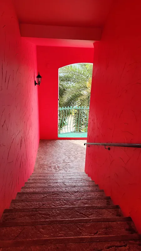 Pink corridor and staircase with palm tree view in Okinawa