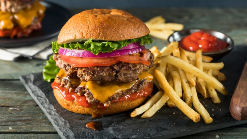 Juicy double cheeseburger with fries at an American-style restaurant in Yomitan