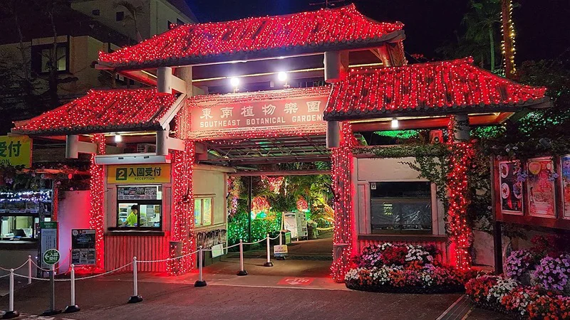 Main entrance of the Southeast Botanical Garden illuminated in red at night in Okinawa
