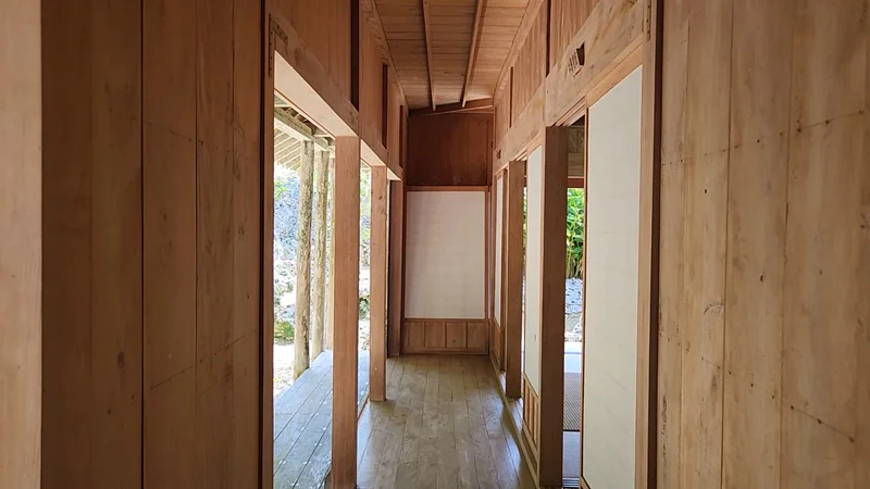 Wooden corridor inside the traditional Okinawan Jitūdē’s house with shoji doors and open hallways.