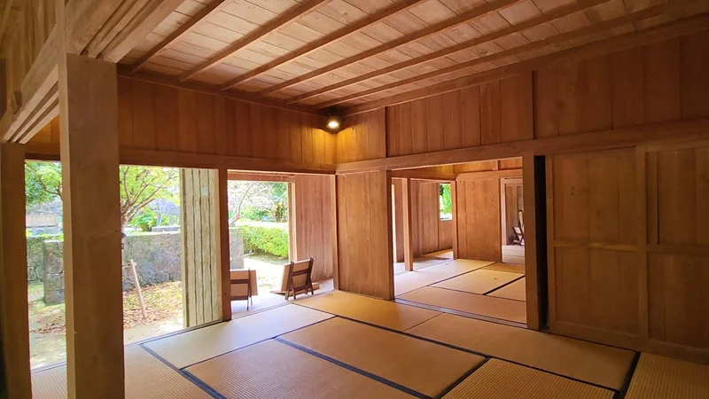 Interior of a traditional Okinawan house with tatami rooms and wooden walls in Jitūdē’s residence.
