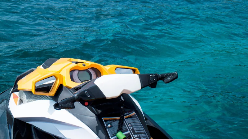 Yellow and white jet ski on turquoise sea in Okinawa