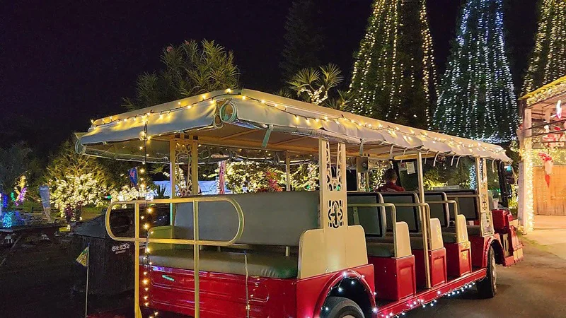 Small bus decorated with lights in front of a café at the Southeast Botanical Garden

