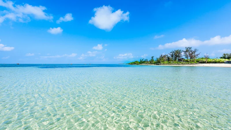 Turquoise sea and white sand under a blue sky in Okinawa