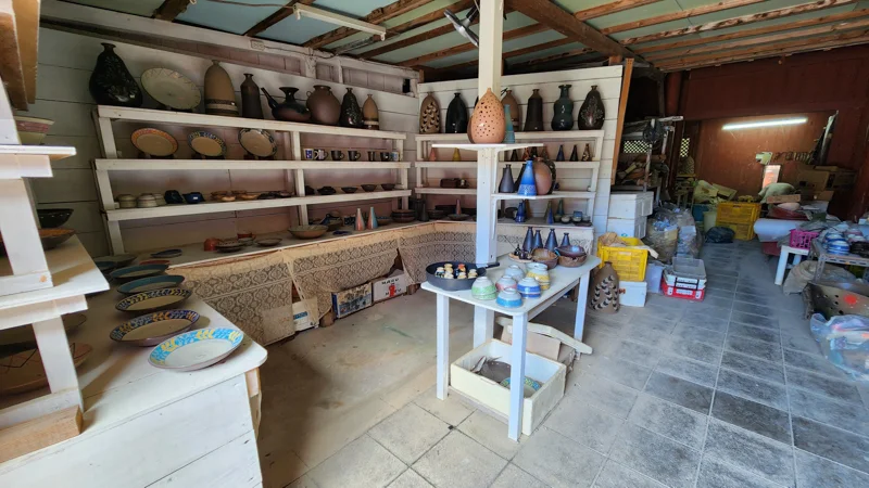 Pottery workshop at Murasaki Mura displaying handmade ceramics and clay vases