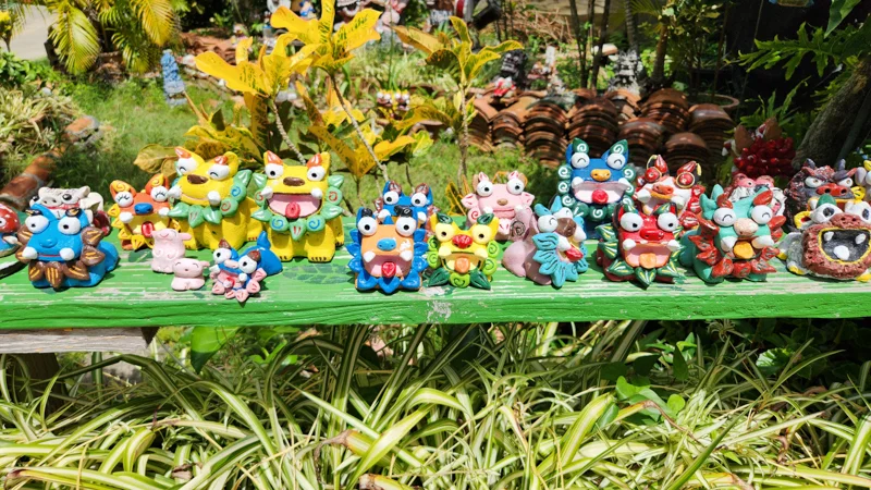 Colorful handmade shisa guardian figurines displayed outdoors