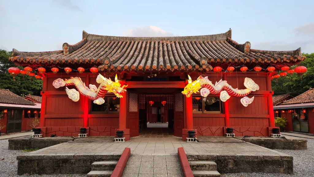 Traditional Ryukyuan building at Murasaki Mura decorated with glowing dragon lanterns and red paper lanterns