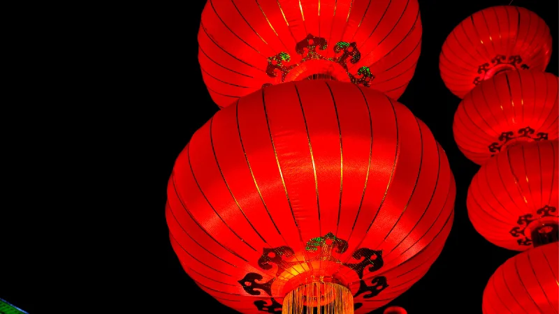 Red paper lanterns illuminated at night during festival in Okinawa