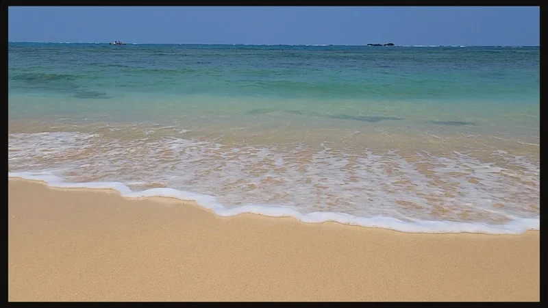 Wave breaking on the sand at Cape Zanpa