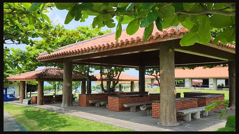 Covered picnic area with traditional roofs at Cape Zanpa