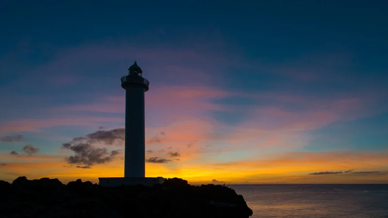 White lighthouse of Zanpa on the cliffs at sunset