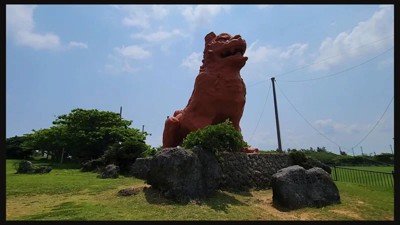 Giant red Shīsā statue at Cape Zanpa