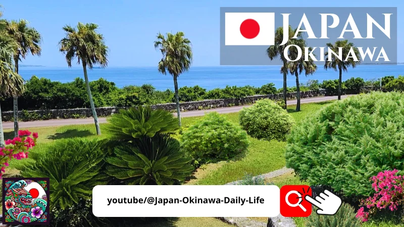 Tropical garden in Okinawa Japan with palm trees, bright green plants and a clear blue ocean in the background, featuring a Japan Okinawa banner and a YouTube channel tag.