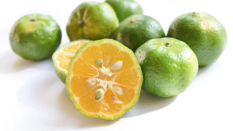 Fresh shikuwasa citrus fruits with one cut open