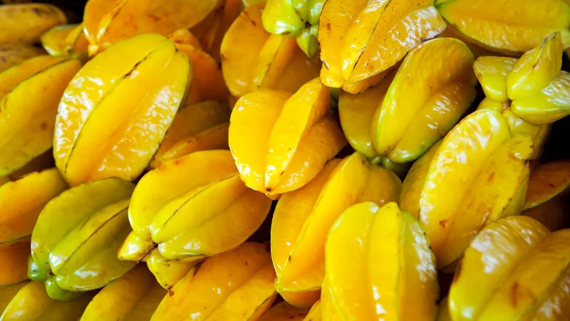 Pile of ripe yellow starfruit at a market