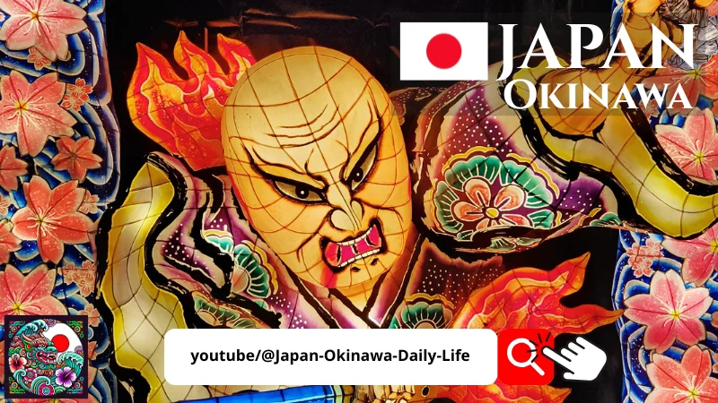 Fierce Japanese warrior figure illuminated at night with floral patterns at a lantern festival in Okinawa.