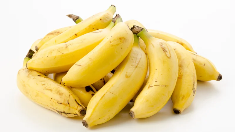 Bunch of ripe Okinawan shima bananas on a white background
