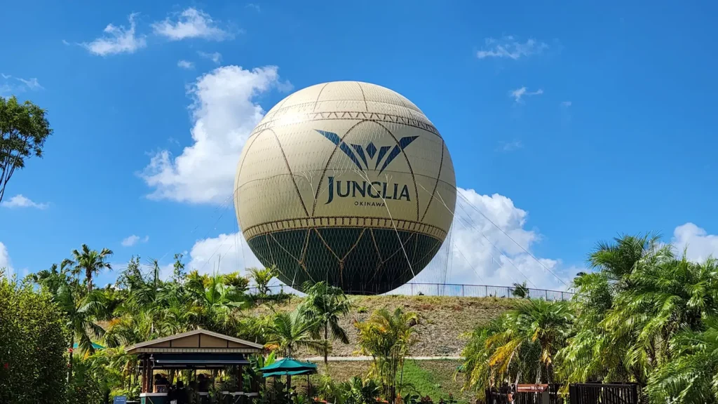 Large Junglia Okinawa hot air balloon against a bright blue sky
