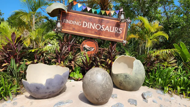 Finding Dinosaurs attraction sign with giant dinosaur egg props at Junglia Okinawa