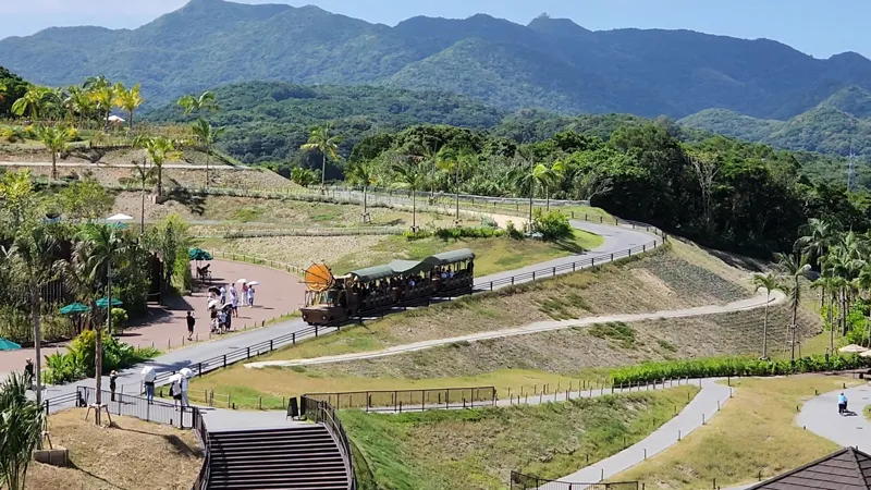 Tam Tam Tram traveling through the hills and tropical scenery at Junglia Okinawa