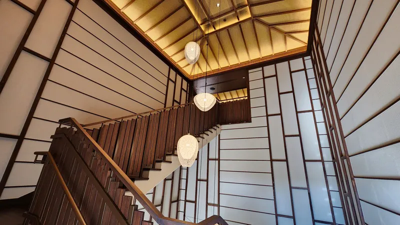 Elegant wooden staircase with soft Japanese style lighting at Junglia Okinawa