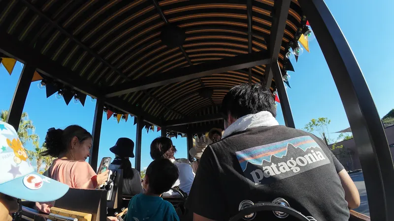 Passengers seated inside the Tam Tam Tram during the ride at Junglia Okinawa