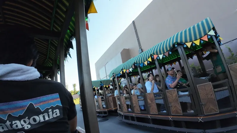 Two Tam Tam Tram carriages passing each other along the ride route at Junglia Okinawa