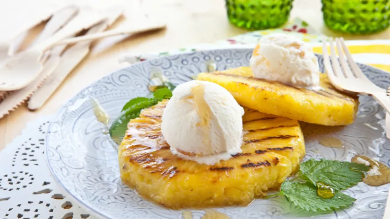 Grilled pineapple slices served with a scoop of ice cream in Okinawa