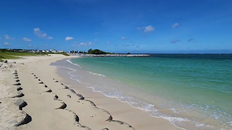 Empty shoreline with gentle waves at Sunset Beach in Chatan Okinawa