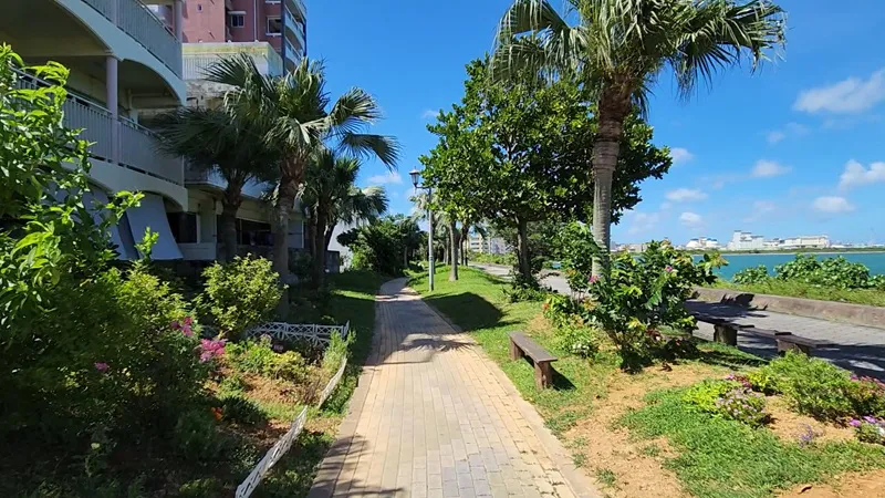 Palm lined pedestrian path near Sunset Beach in Chatan Okinawa on a sunny day