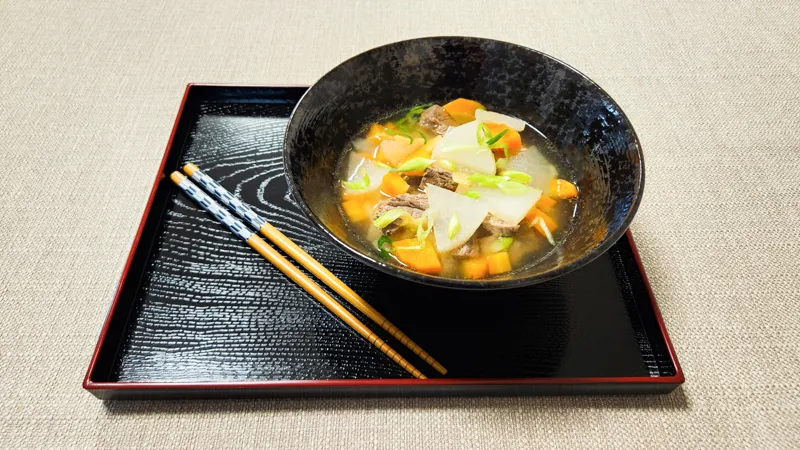 Homemade Japanese beef soup with ginger, daikon, and vegetables