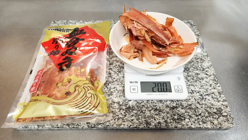 Dried bonito flakes weighed on a kitchen scale for dashi