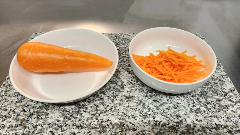 Whole carrot and julienned carrot prepared for cooking