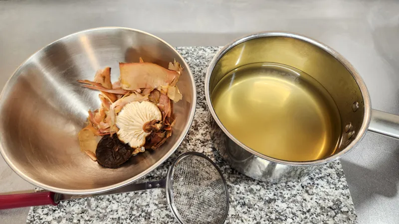 Clear dashi broth separated from bonito flakes and shiitake mushrooms