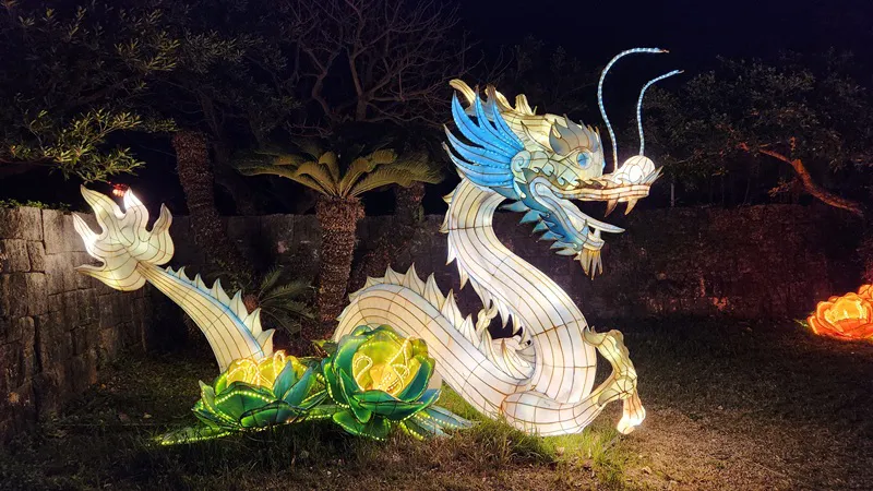 Large illuminated dragon lantern displayed outdoors at Murasaki Mura in Okinawa Japan