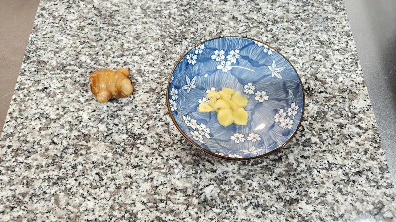 Fresh ginger root and sliced ginger on a plate